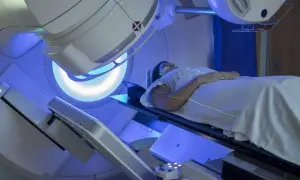 Pacjentka leży pod aparatem do radioterapii. Trudno ocenić, co gorsze chemioterapia czy radioterapia, ale obie metody leczenia raka są wyzwaniem.